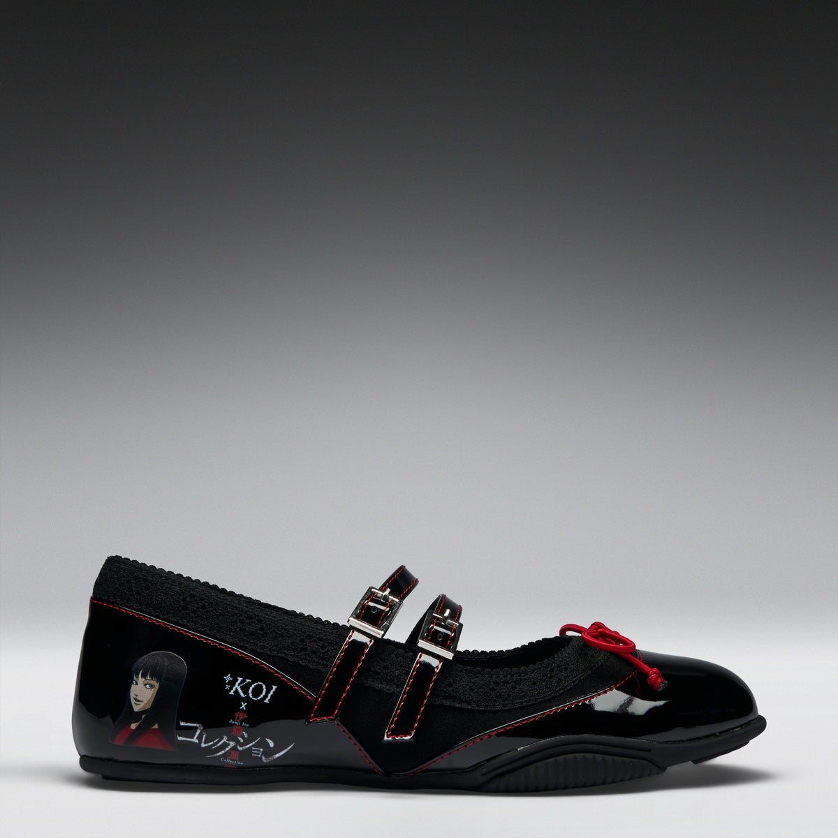 A black Mary Jane-style shoe with double straps, red contrast stitching, a red bow detail, and graphic character artwork on the side, photographed on a gray gradient studio background.