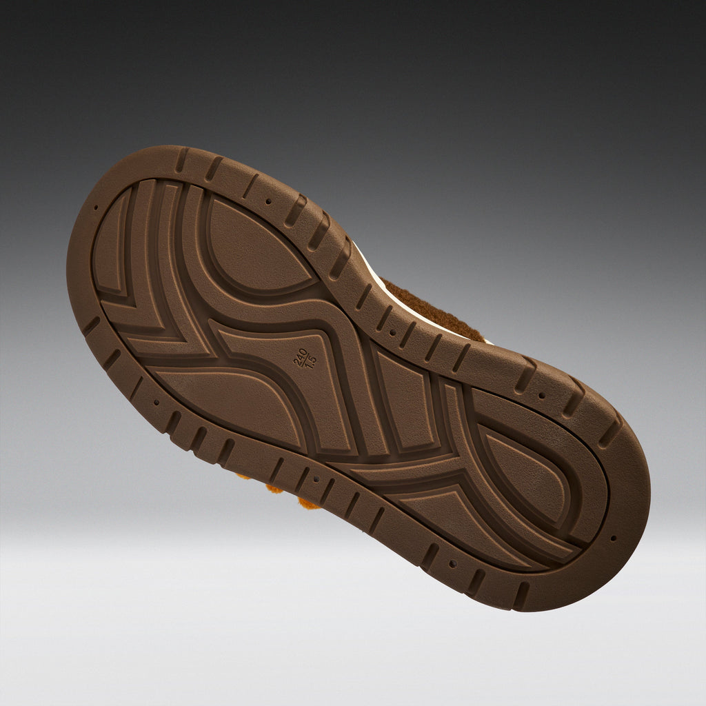 Brown shoe sole on a gradient gray background